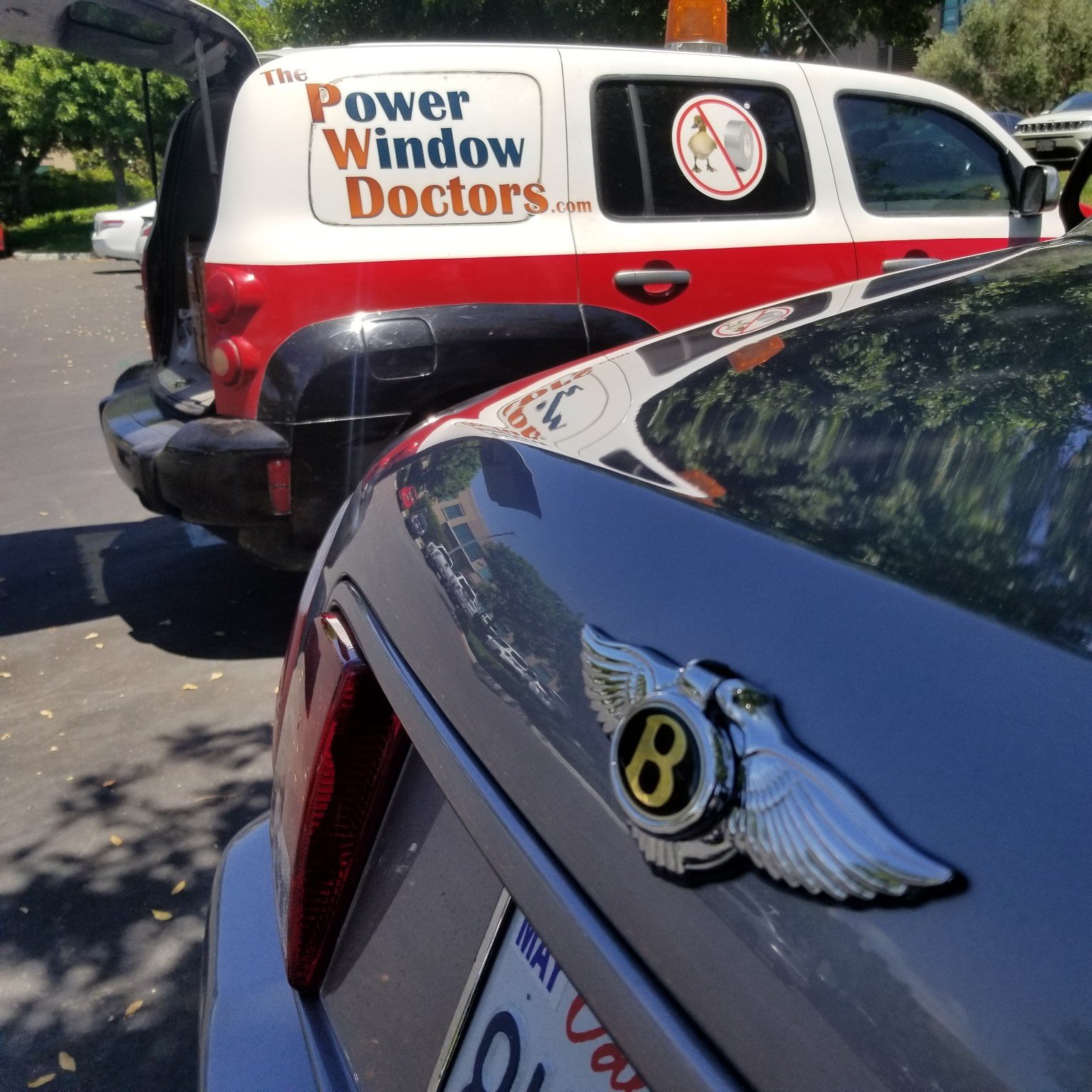 Power Window Doctors mobile service vehicle beside a customer car